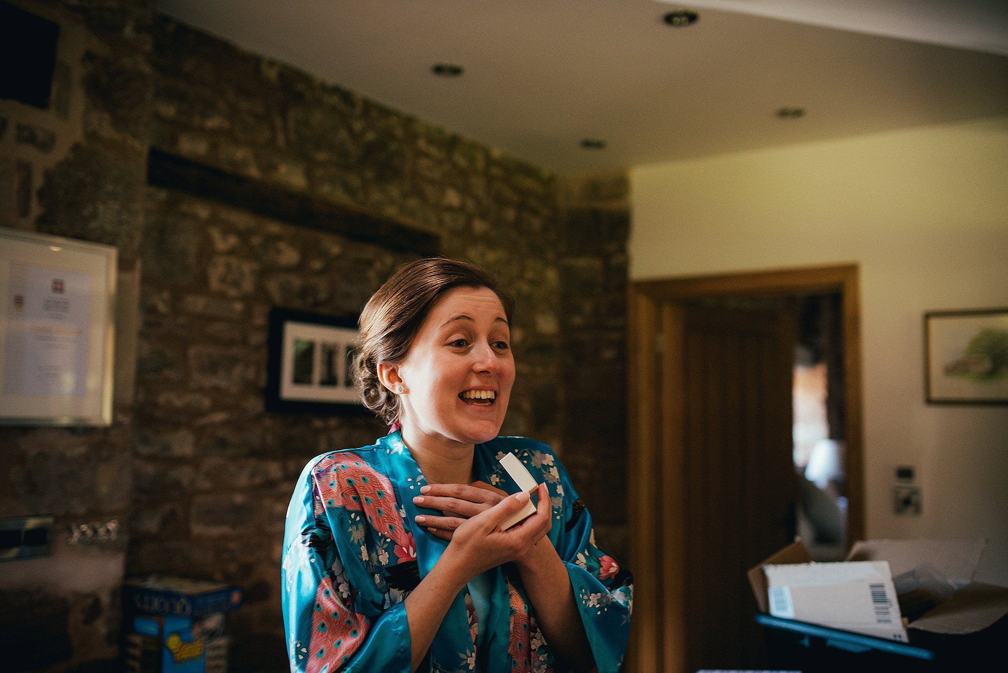 Happy bride opening presents at flanesford priory