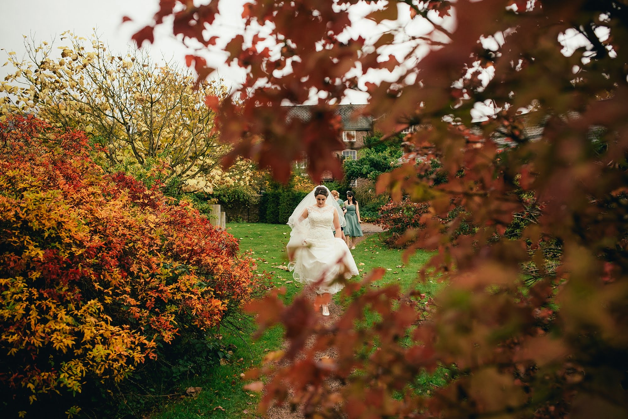 bride through trees in Herefordshire